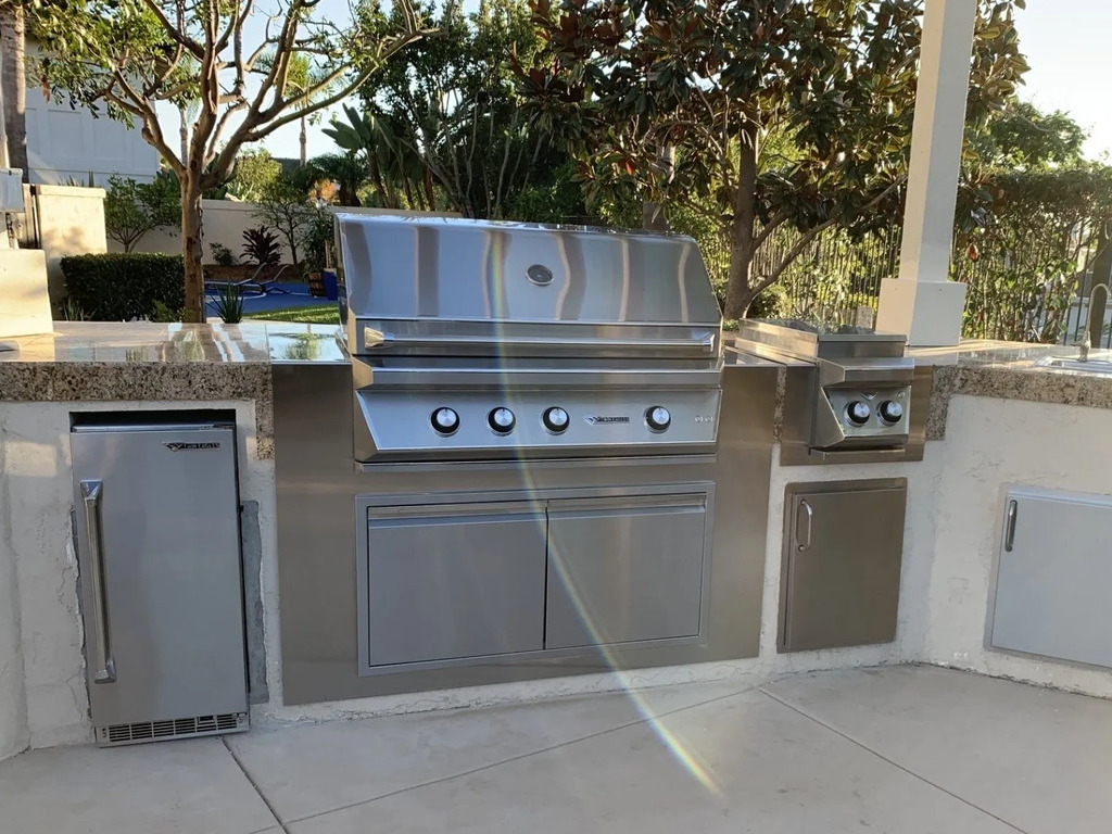 Luxury outdoor kitchen with stainless steel appliances.