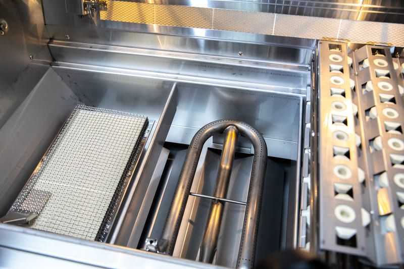 Inside view of a clean BBQ grill and burners.