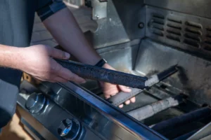 Close-up of grill cleaning, removing grease from grate