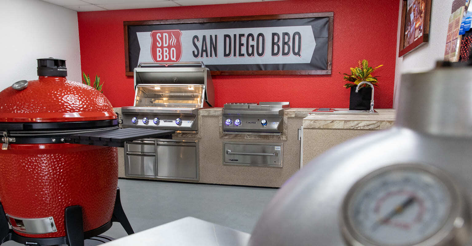 BBQ showroom with grills and company banner.