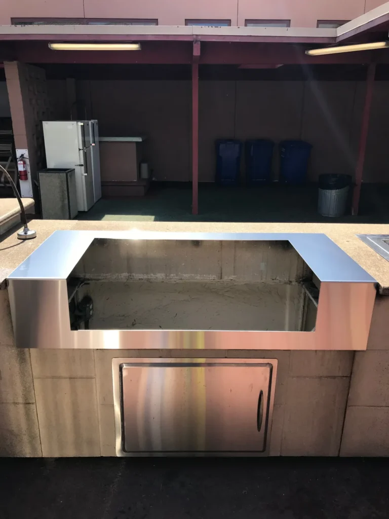 A stainless GrillFitter frame fitted into the cut-out of an existing outdoor island, ready for the new grill