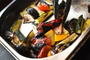 Baked mixed vegetables in a stainless steel tray