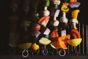Colorful vegetable skewers on grill ready to cook