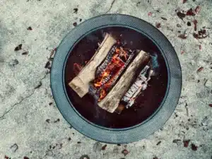 Wood logs burning in an outdoor fire pit