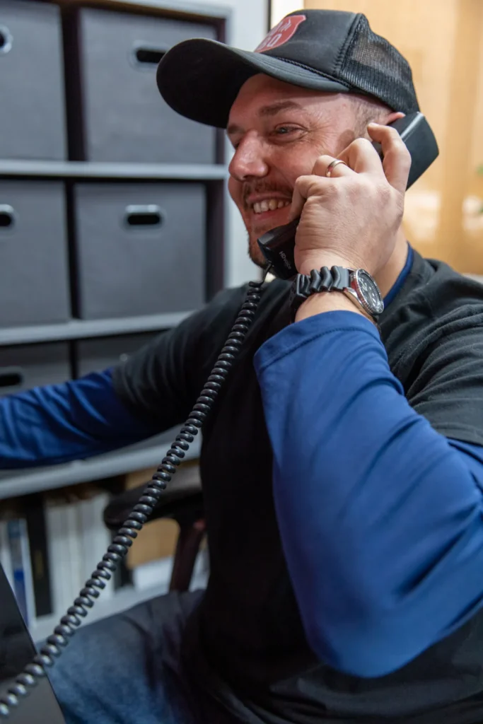 A member of the SDBBQ team on the phone in the office