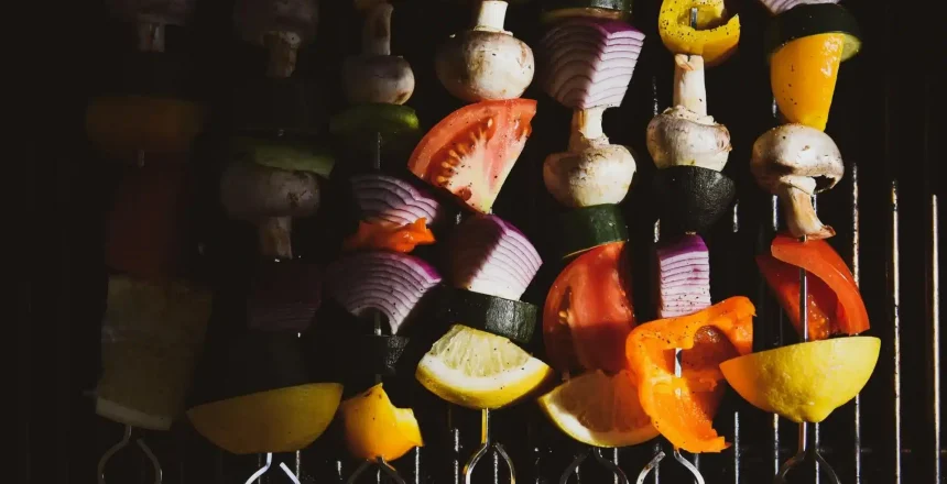 Colorful vegetable skewers on grill ready to cook